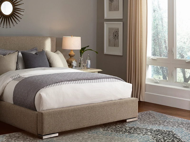 Patterned area rug in a taupe bedroom